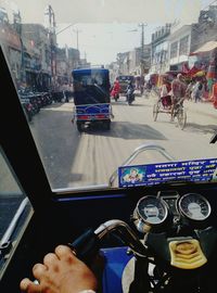 Man driving car on road in city