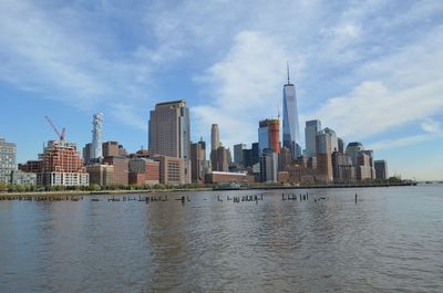 River by buildings against sky in city.