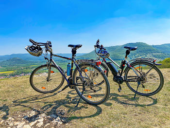 Bicycles on field against sky