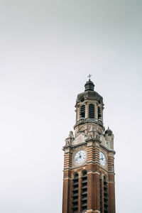 Low angle view of clock tower against sky