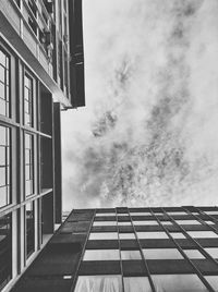 Low angle view of buildings against cloudy sky