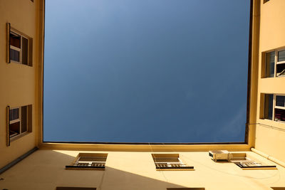 Building against sky seen through window