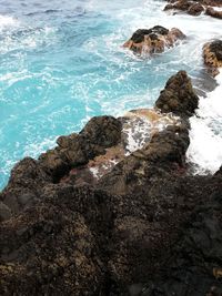 High angle view of rocks in sea