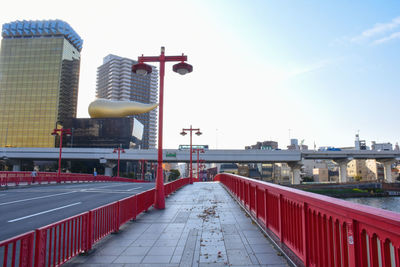 Bridge over river in city against clear sky