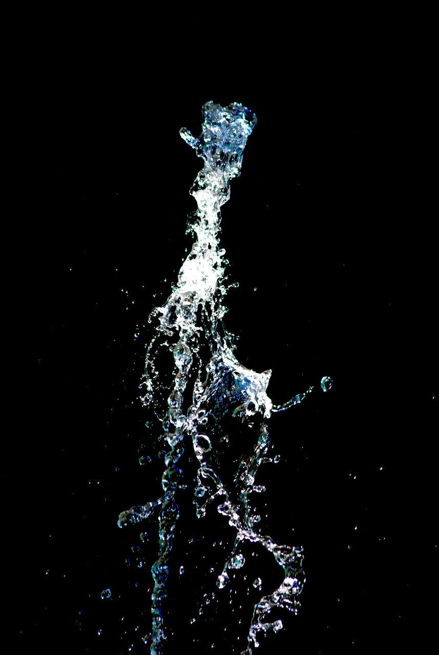 CLOSE-UP OF WATER SPLASHING AGAINST STAR SHAPE