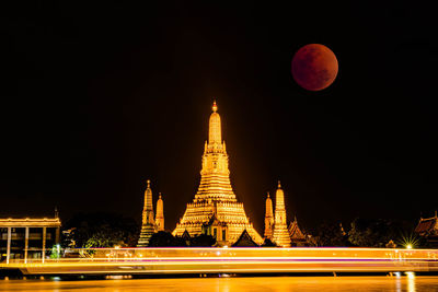 Lunar eclipse, super red full moon taken from top side of  wat arun temple in bangkok thailand.