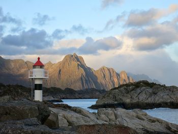 Scenic view of sea and mountains against sky