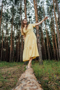 Peace of mind, breathing fresh air. alone woman in dress lying on tree