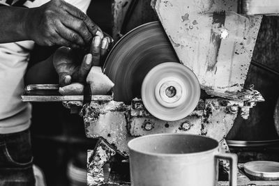 Close-up of man working in machine