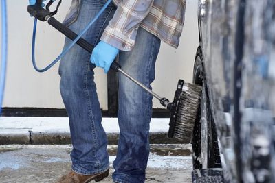 Low section of man working on  carwash 