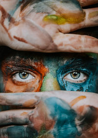 Close-up portrait of man  with face painted 