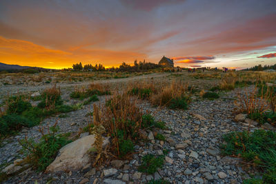 Scenic view of field against sky during sunset