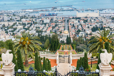 High angle view of statue amidst trees and buildings in city