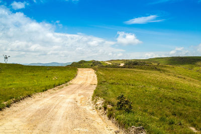 Dirt road along countryside landscape