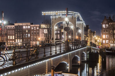  illuminated drawbridge at night time in amsterdam over the river amstel