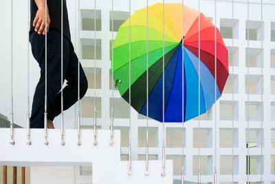 Low section of multi colored umbrella in the stairs wall