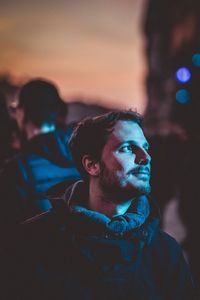 Portrait of young man looking away outdoors