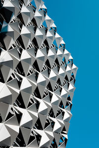 A low angle view of a cheese grater like building exterior. 