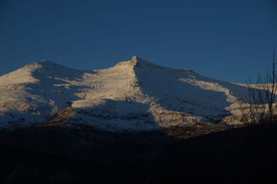 Scenic view of mountains against clear blue sky