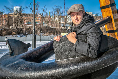 Portrait of man holding ice during winter