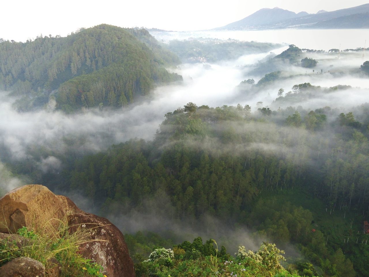 mountain, tranquil scene, scenics, tranquility, beauty in nature, mountain range, landscape, nature, water, non-urban scene, idyllic, fog, high angle view, sky, physical geography, remote, lake, geology, day, outdoors