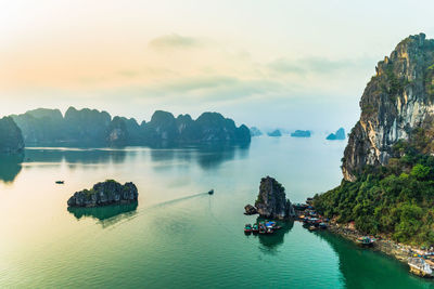 Panoramic view of boats in sea against sky