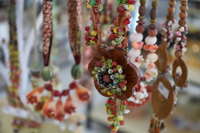 Close-up of beaded necklace on market stall for sale