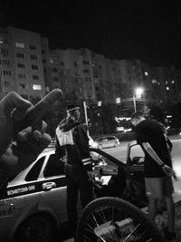 Man standing on street in city at night