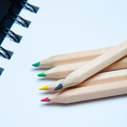 Close-up of colored pencils against white background