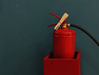 Close-up of red light on table against wall