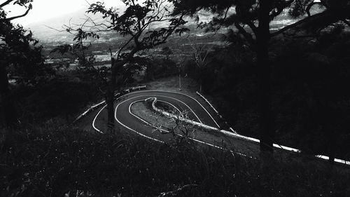 High angle view of curved mountain road amidst trees