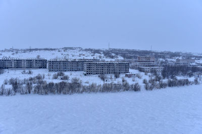 Aerial view of buildings against clear sky during winter