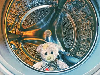 Close-up of teddy bear in washing machine