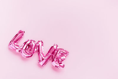 High angle view of pink petals on white background