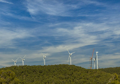 Windmill on field against sky