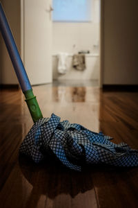 Close-up of mop on floor at home