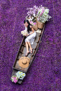 High angle view of woman standing by potted plant