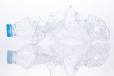 Close-up of ice on table against white background