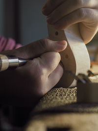 Luthier working a classic violin scroll