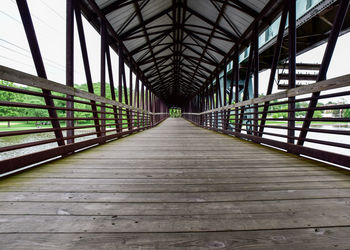 Diminishing perspective of covered bridge over river