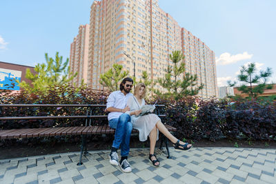 Full length of woman sitting on seat