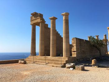 Ruins of doric temple against clear sky