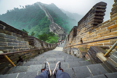 Man sitting on great wall of china