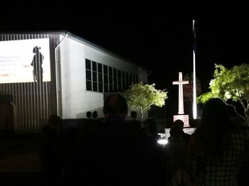 Rear view of people in illuminated building