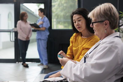 Side view of doctor examining patient in office