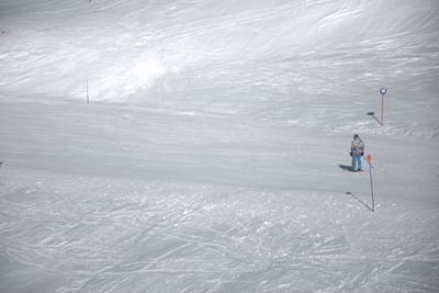 High angle view of man skiing on snow covered field