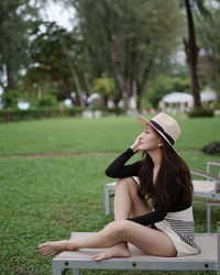 Woman sitting on chair in park