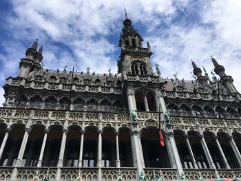 Low angle view of historical building against cloudy sky