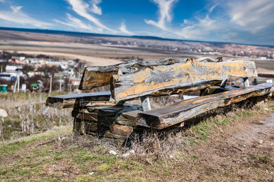 Abandoned truck on field against sky