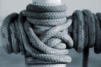 Close-up of rope coiled around pole